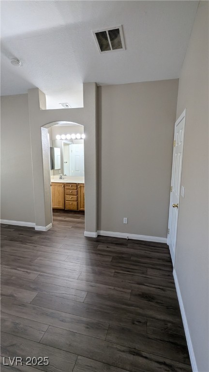 9121 Watermelon Seed Avenue Las Vegas, NV 89143 - Photo 18 of 21 Spare room with dark wood-style flooring, arched walkways, and a smoke detector