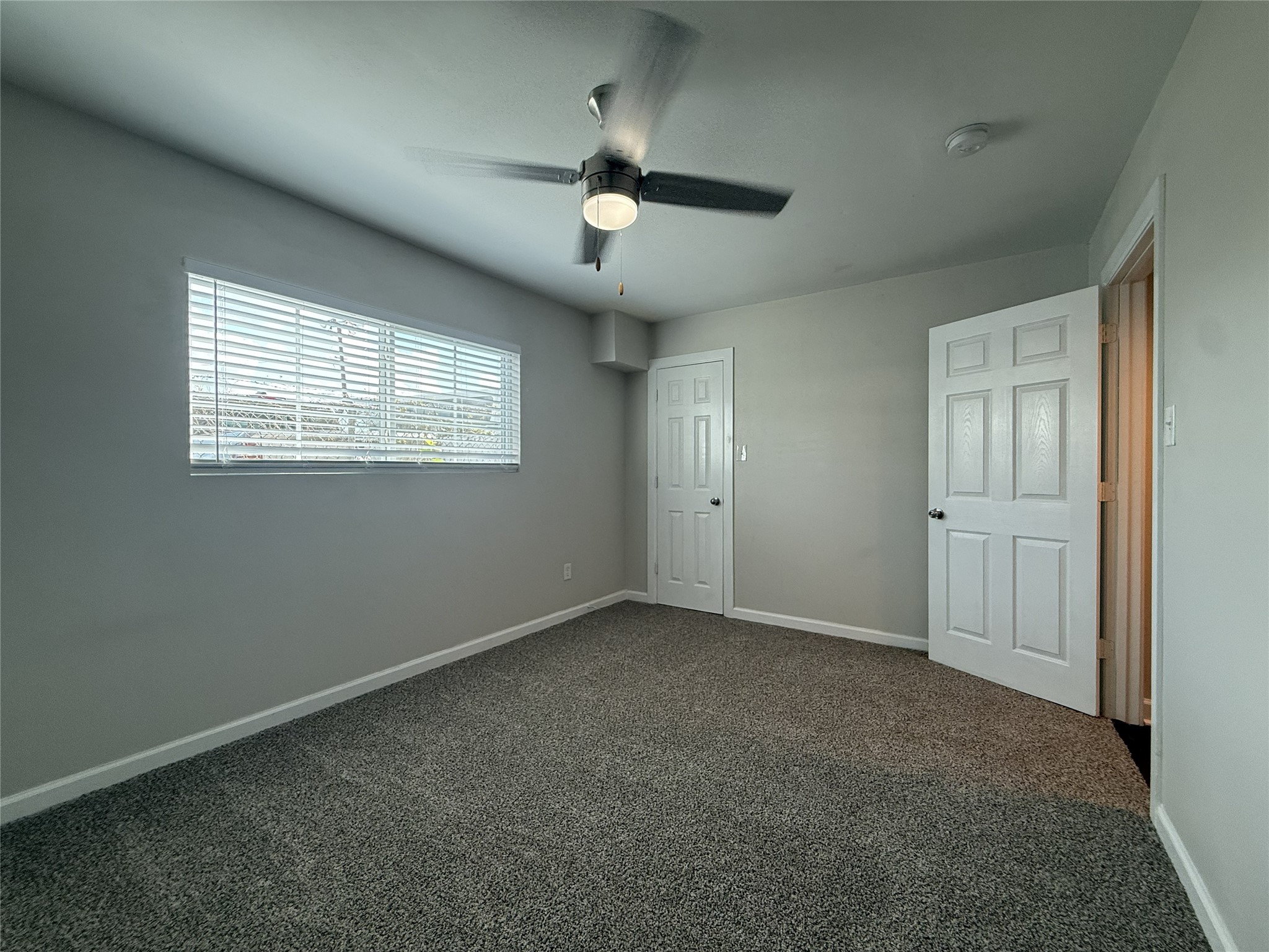 1824 Thonig Road, Unit 10 Houston, TX 77055 - Photo 8 of 17 an empty room with chandelier fan and windows