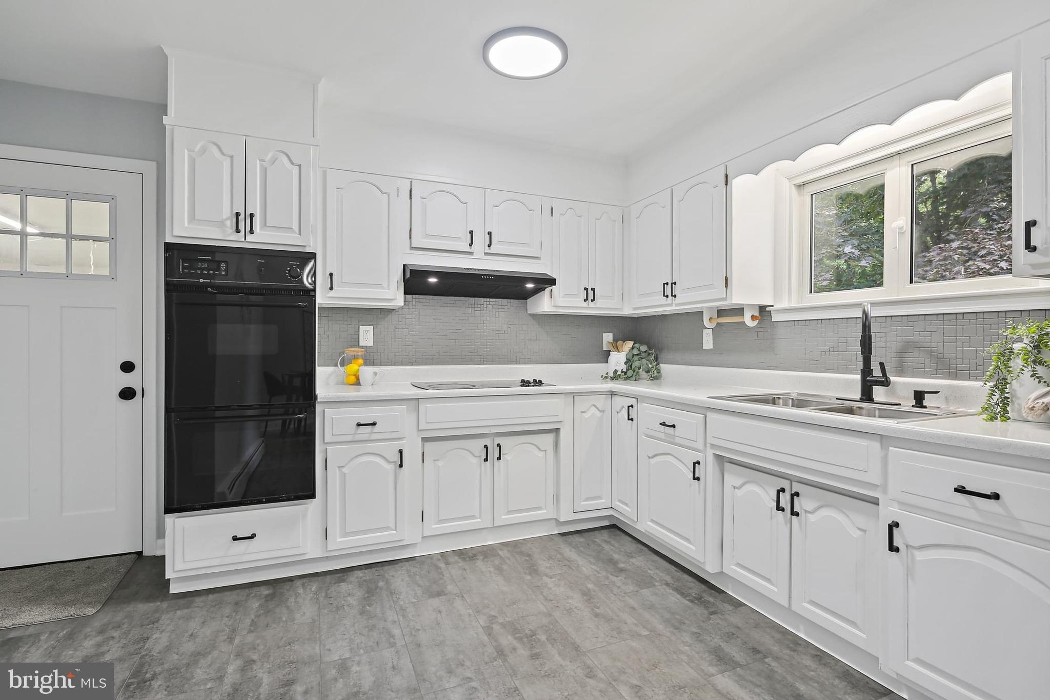 1516 Singer Road Joppa, MD 21085 - Photo 11 of 39 a kitchen with cabinets appliances a sink and a window