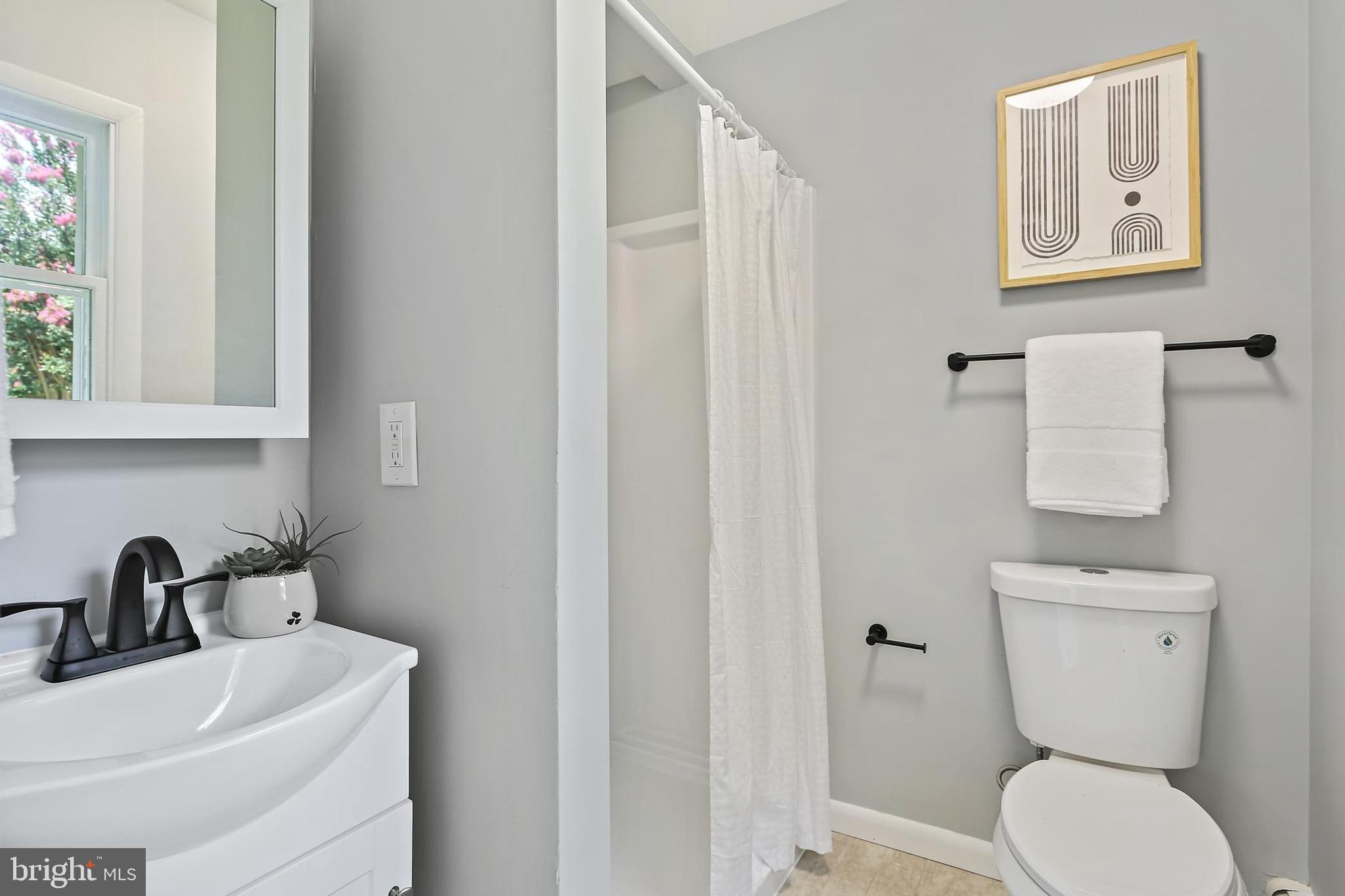 1516 Singer Road Joppa, MD 21085 - Photo 15 of 39 a bathroom with a toilet sink and mirror