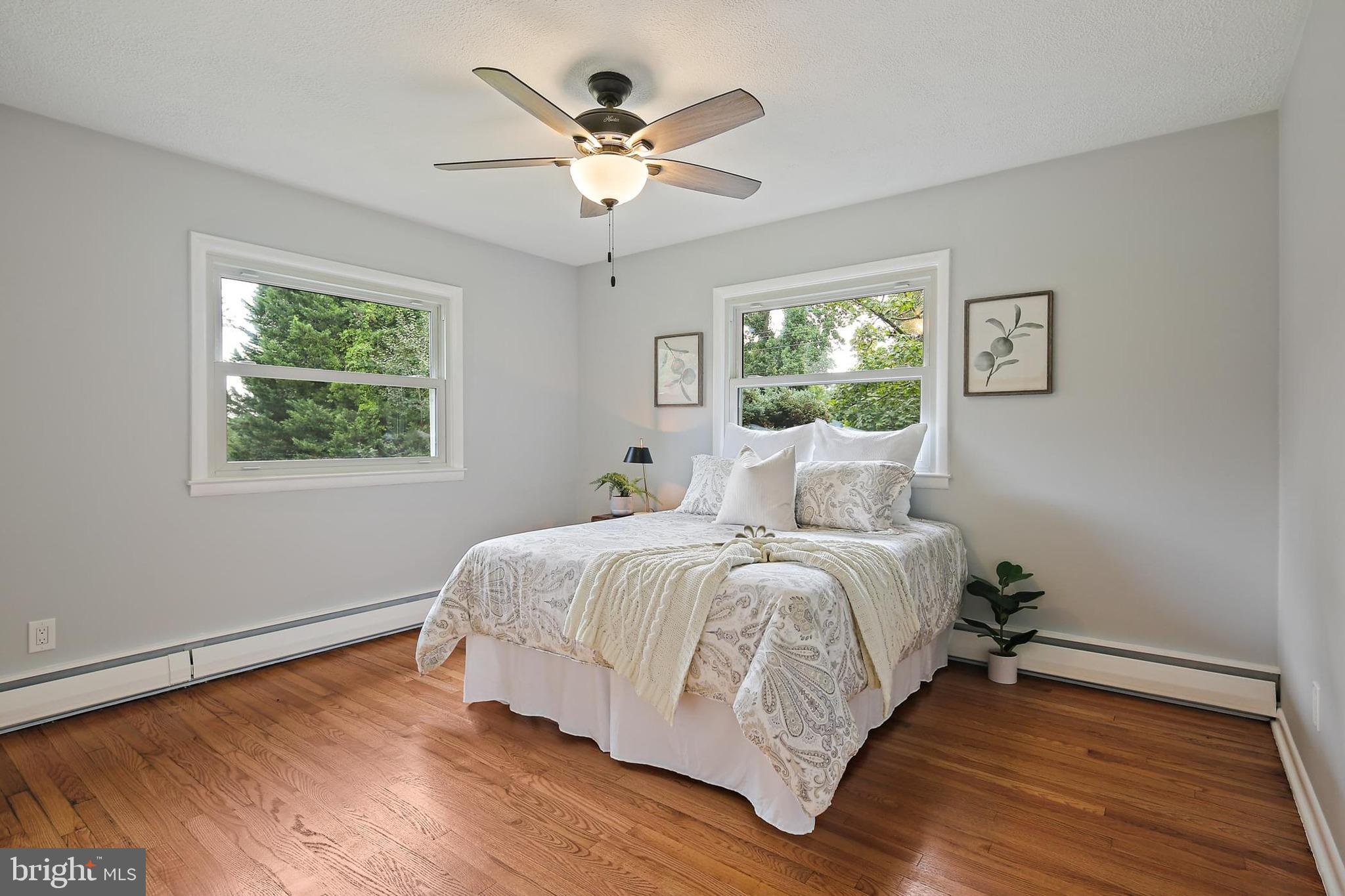 1516 Singer Road Joppa, MD 21085 - Photo 17 of 39 a spacious bedroom with a large bed chandelier and a window