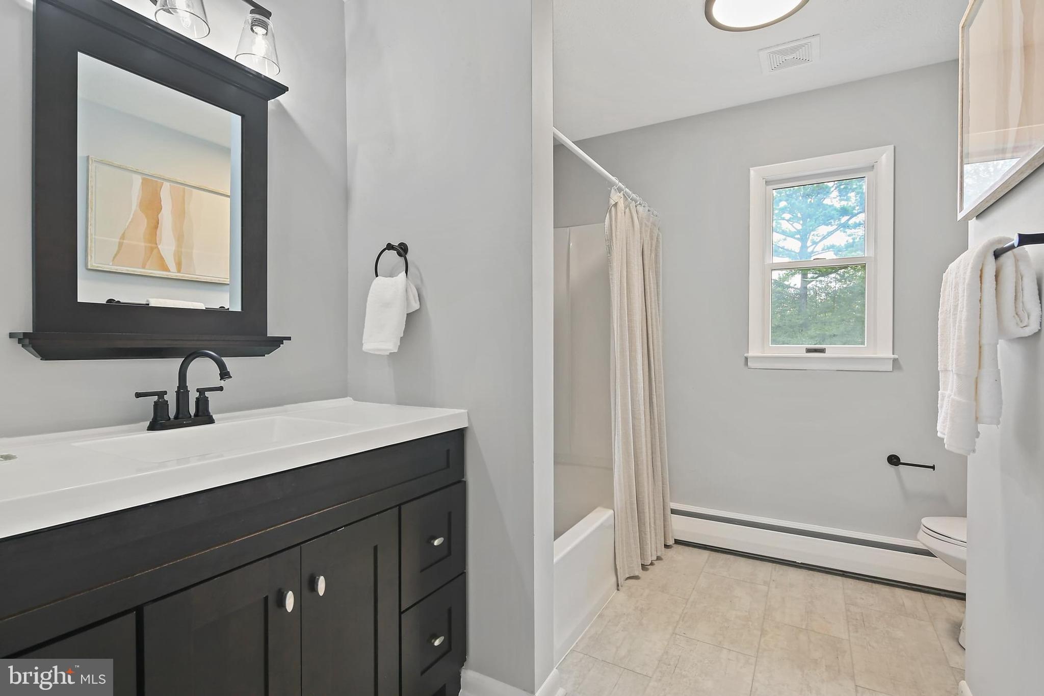 1516 Singer Road Joppa, MD 21085 - Photo 21 of 39 a bathroom with a sink vanity granite and a mirror