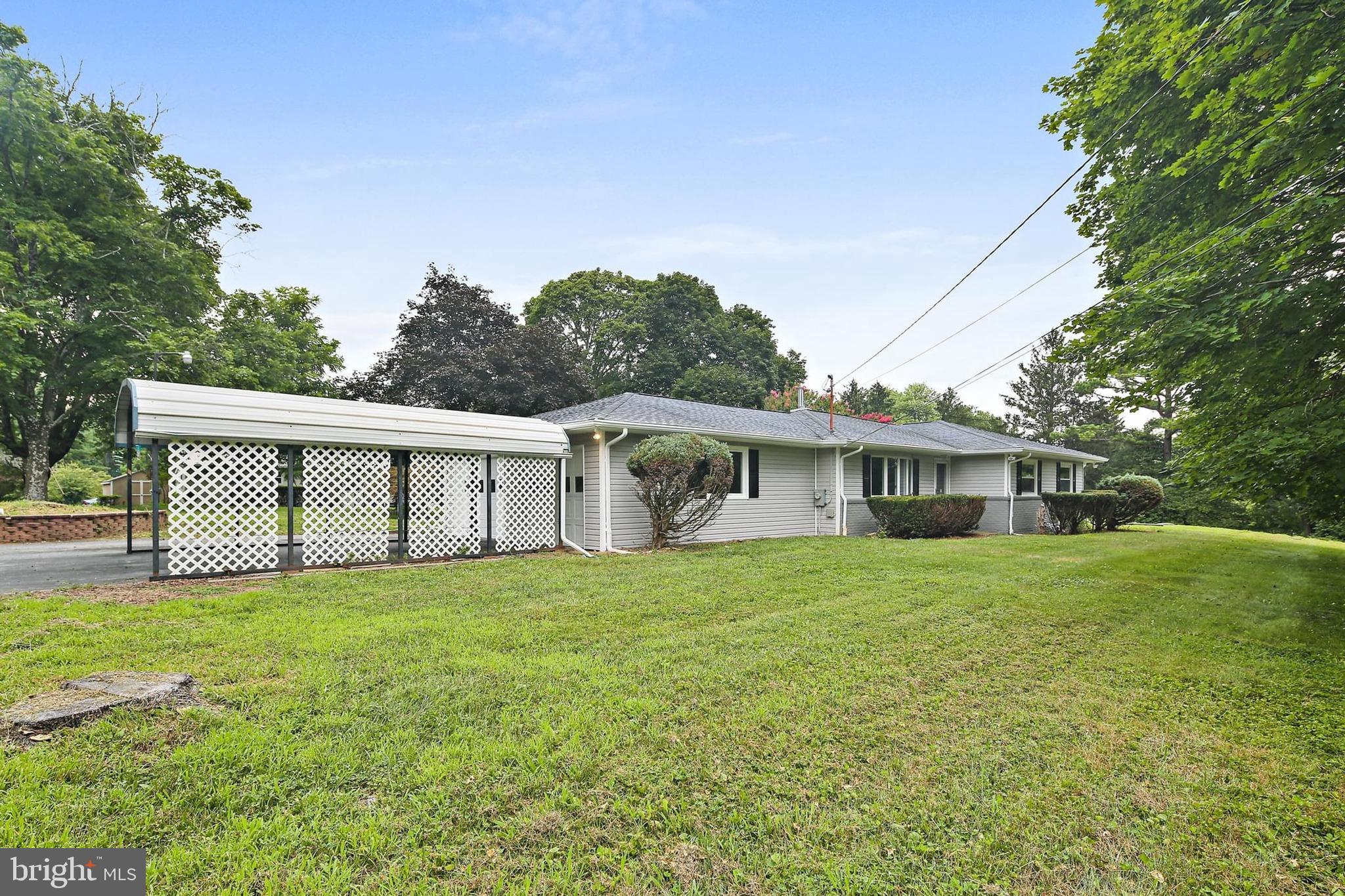 1516 Singer Road Joppa, MD 21085 - Photo 3 of 39 a view of a yard in front of a house with large trees