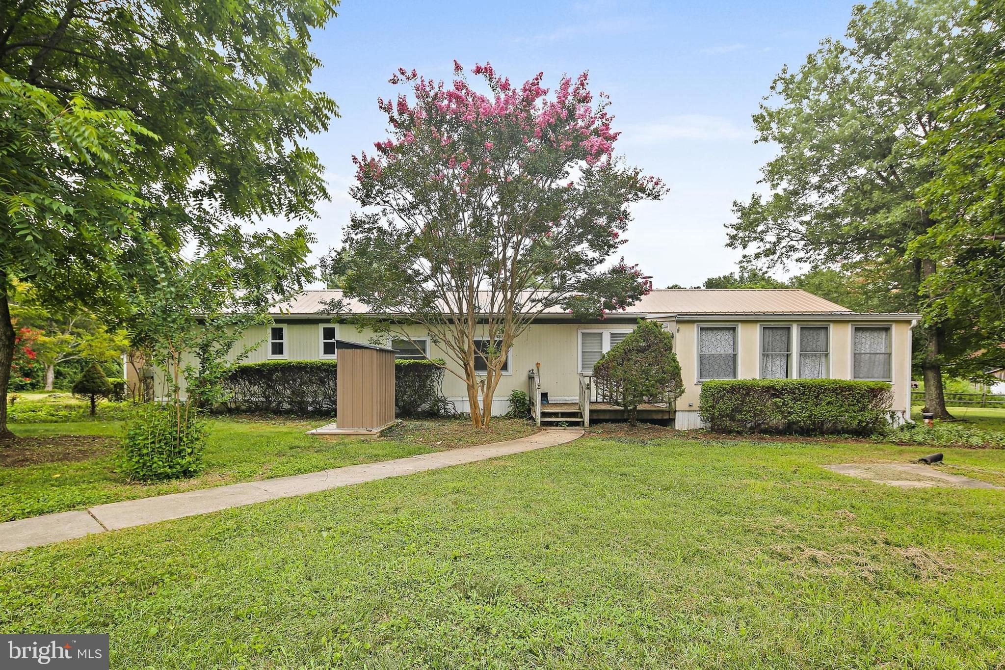1516 Singer Road Joppa, MD 21085 - Photo 33 of 39 a front view of a house with a garden and trees