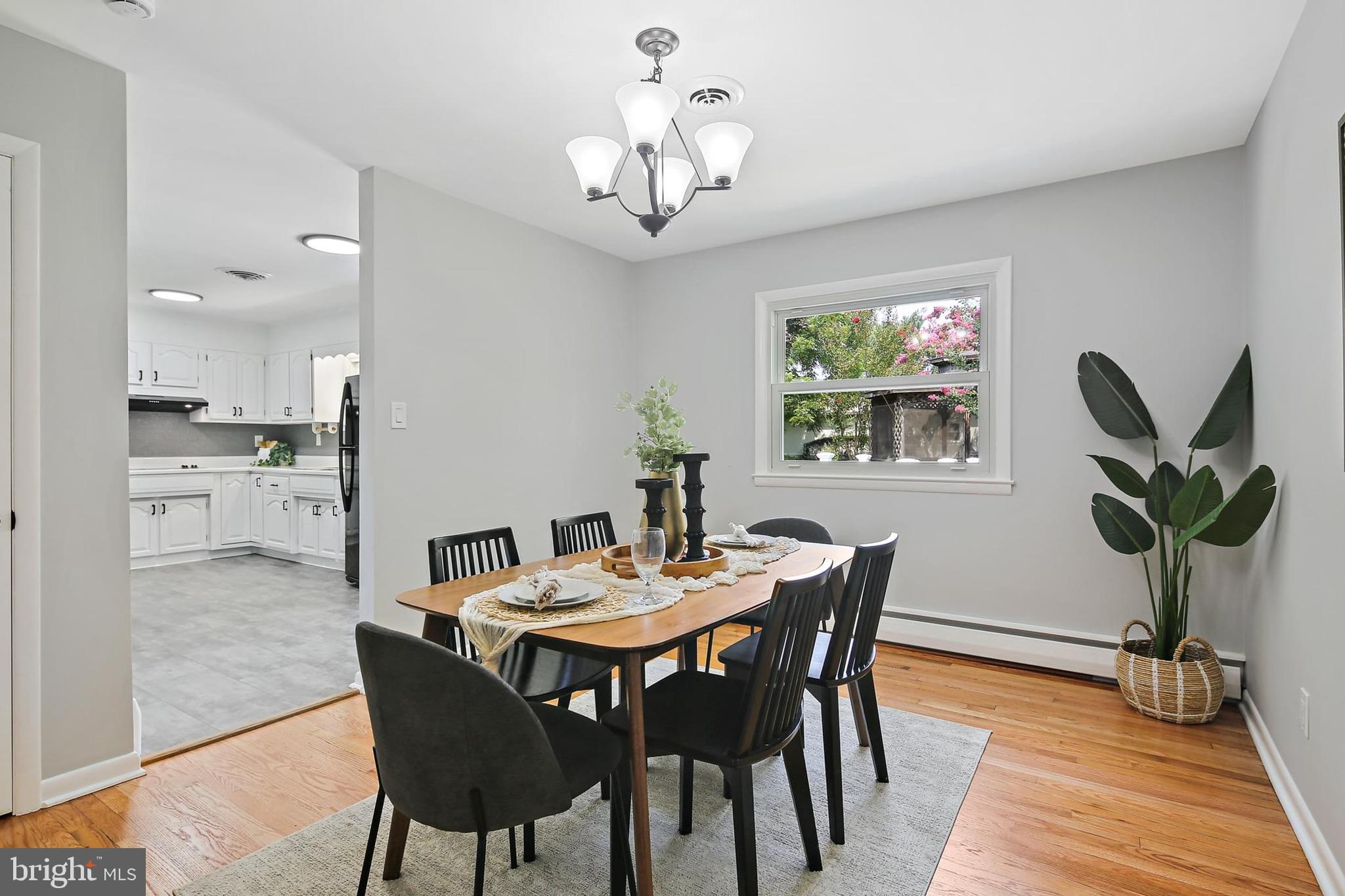 1516 Singer Road Joppa, MD 21085 - Photo 7 of 39 a view of a dining room with furniture a chandelier and wooden floor