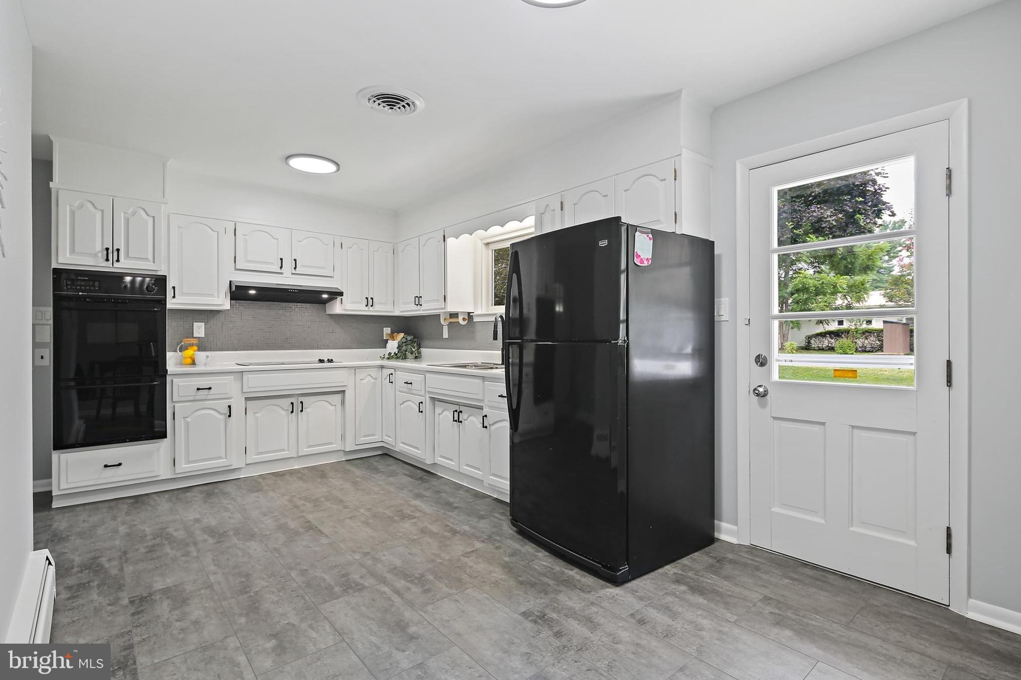 1516 Singer Road Joppa, MD 21085 - Photo 9 of 39 a kitchen with granite countertop a refrigerator and a sink