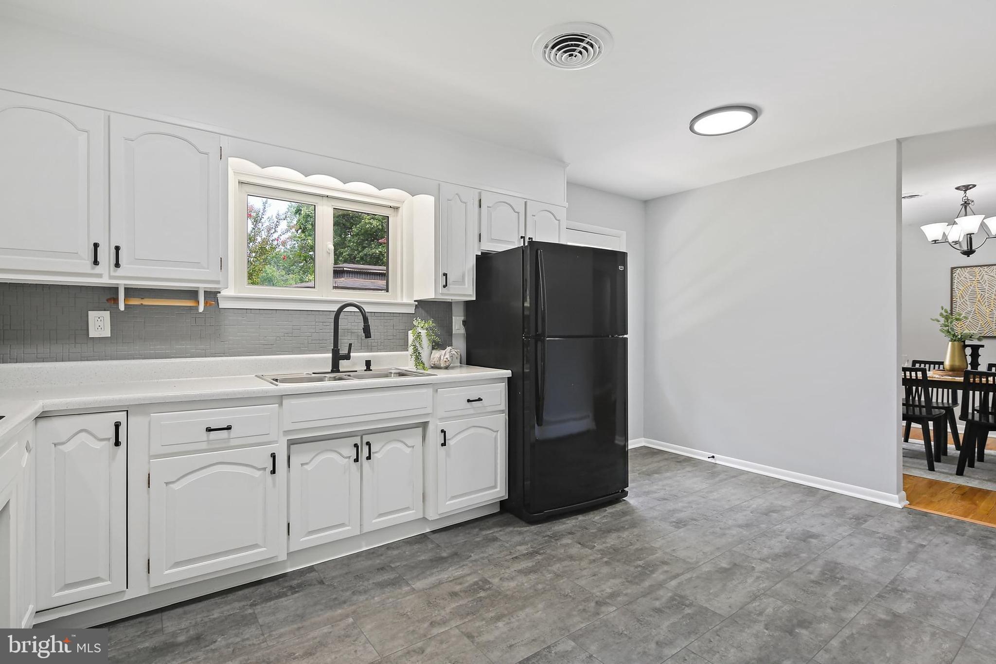 1516 Singer Road Joppa, MD 21085 - Photo 10 of 39 a kitchen with a refrigerator sink and cabinets