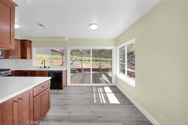 a view of a kitchen with a sink and wooden floor