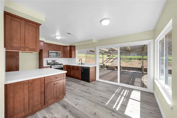 a large kitchen with a large window and stainless steel appliances