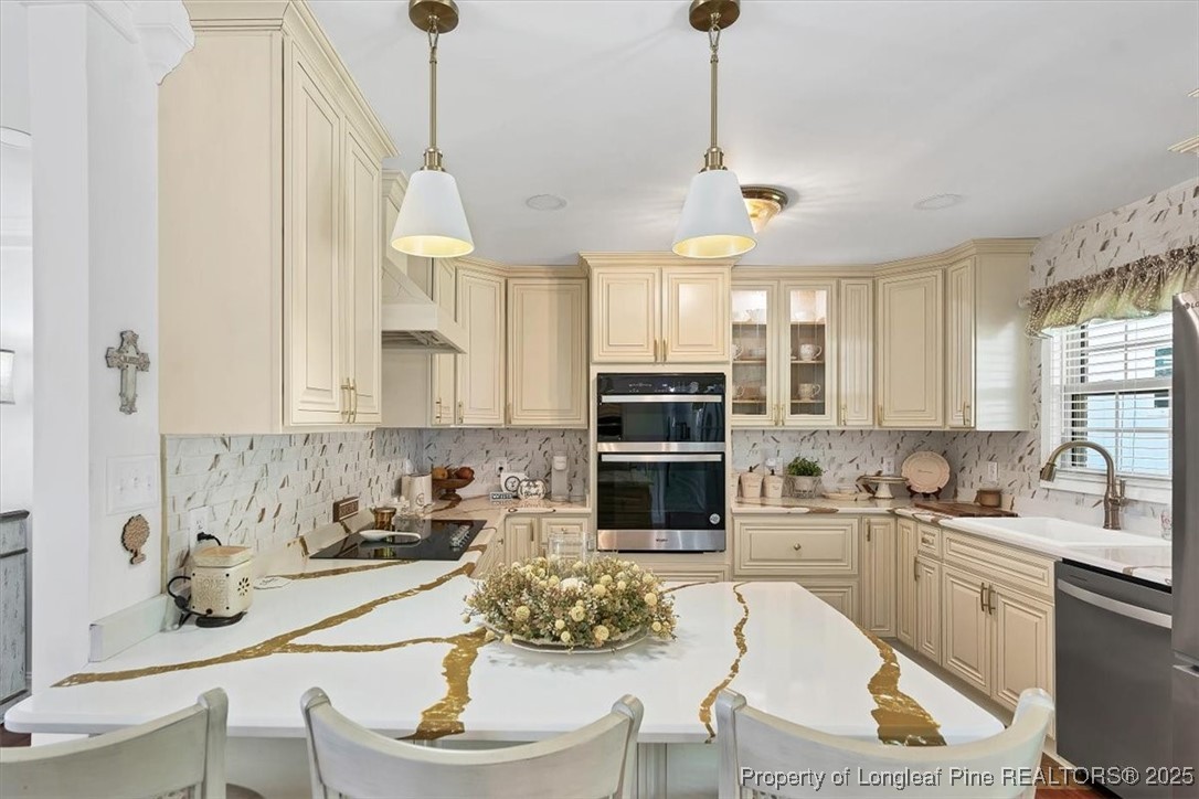 2483 West Carthage Road Lumberton, NC 28360 - Photo 13 of 50 a kitchen with stainless steel appliances granite countertop a sink a stove a refrigerator cabinets and chairs