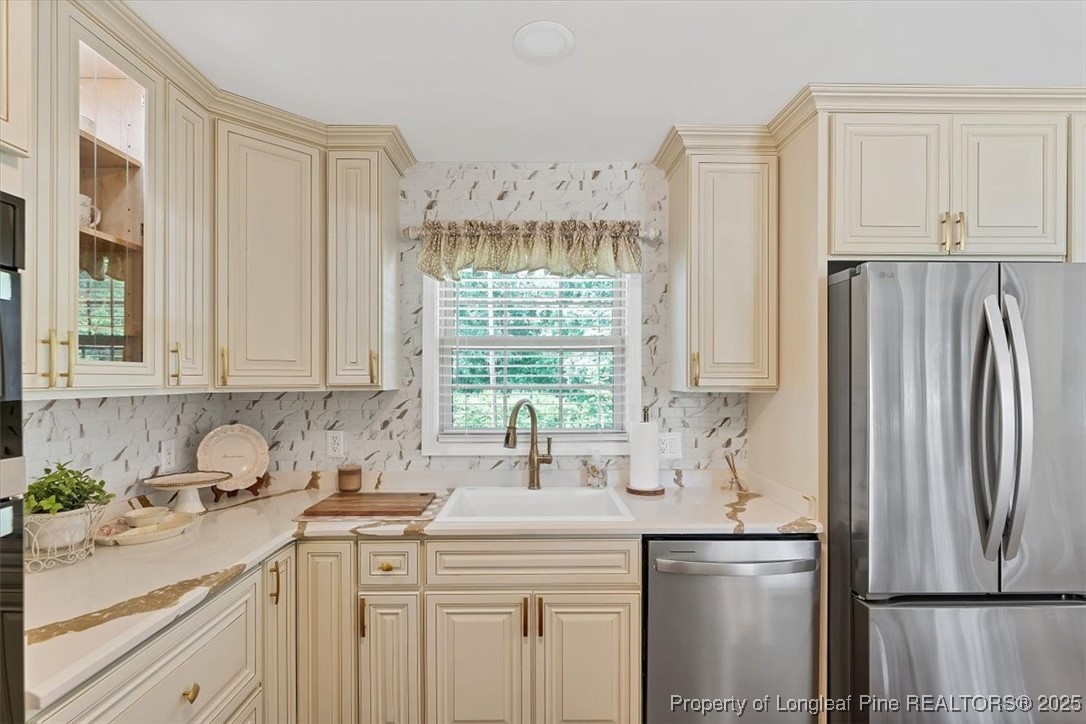 2483 West Carthage Road Lumberton, NC 28360 - Photo 16 of 50 a kitchen with stainless steel appliances a sink a refrigerator and a window