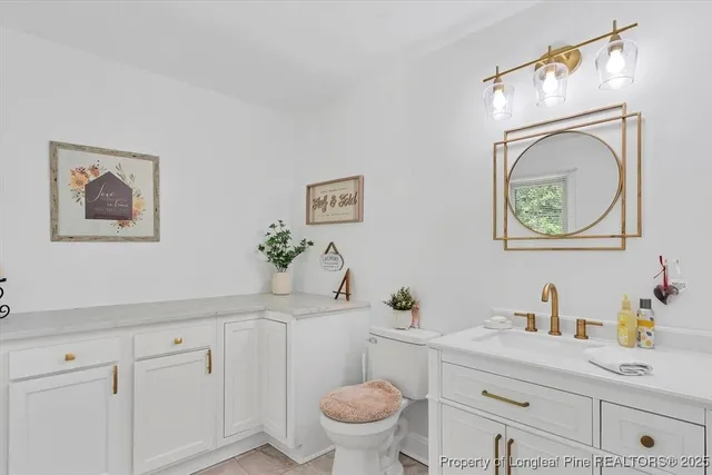 a bathroom with a sink mirror and vanity