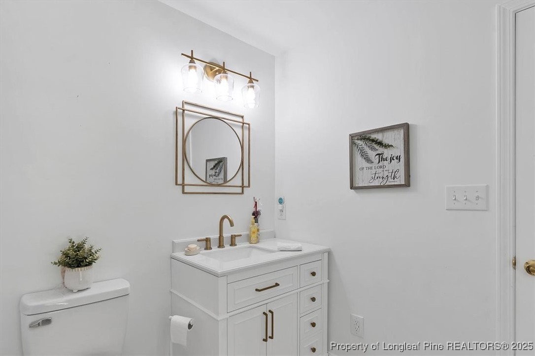 2483 West Carthage Road Lumberton, NC 28360 - Photo 28 of 50 a bathroom with a sink mirror and vanity