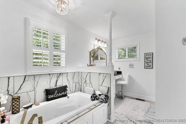 a bathroom with a granite countertop sink a mirror and shower