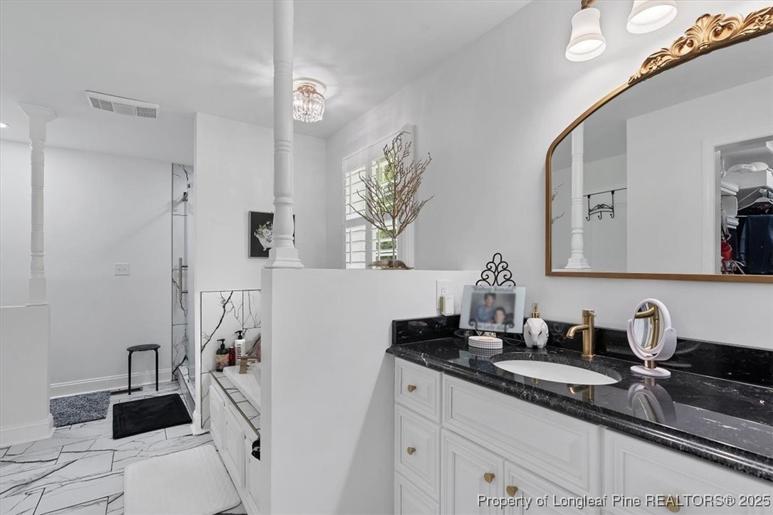 2483 West Carthage Road Lumberton, NC 28360 - Photo 36 of 50 a bathroom with a granite countertop sink a mirror and shower