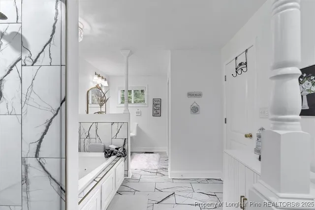 a bedroom with a large bed and a dresser