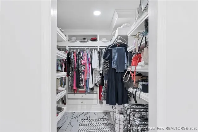 a bedroom with a bed a television and a window