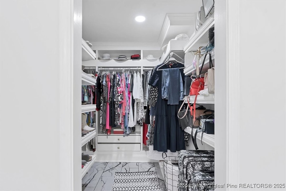 2483 West Carthage Road Lumberton, NC 28360 - Photo 38 of 50 a view of walk in closet with clothes and shoes