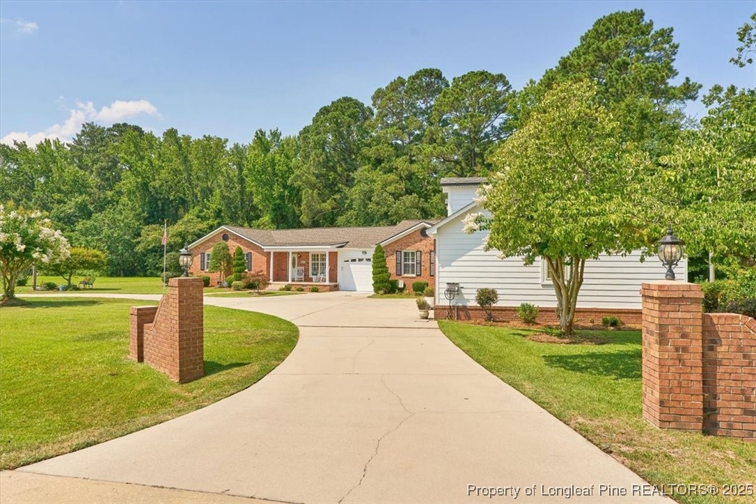 2483 West Carthage Road Lumberton, NC 28360 - Photo 4 of 50 a front view of a house with garden