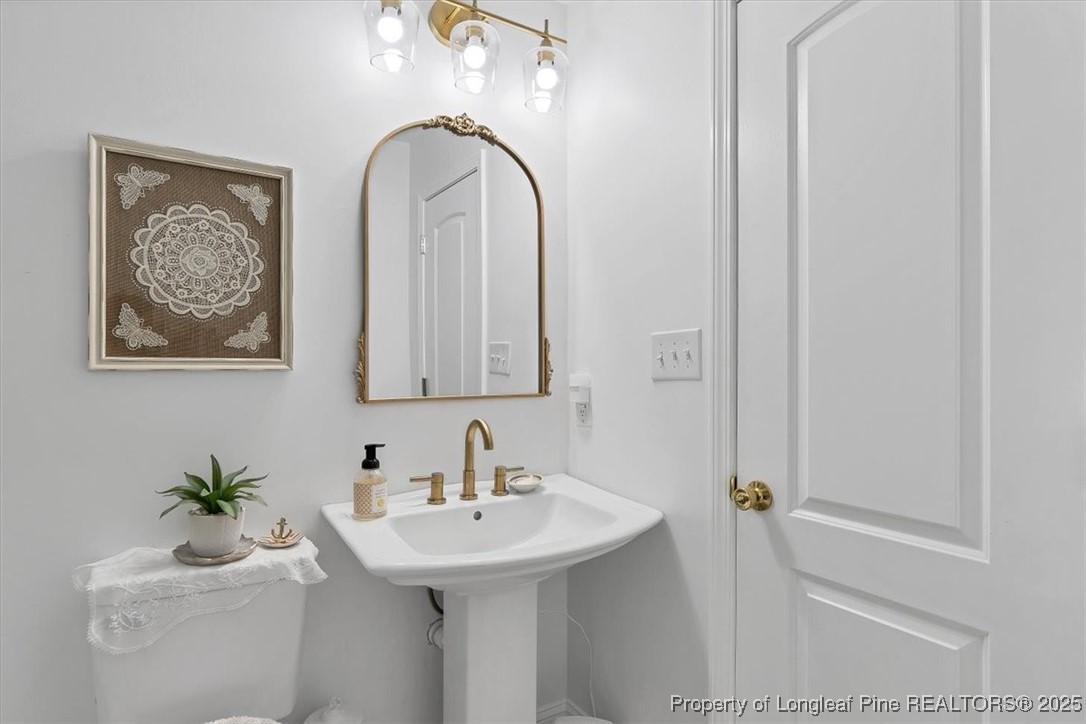 2483 West Carthage Road Lumberton, NC 28360 - Photo 44 of 50 a bathroom with a sink and a mirror