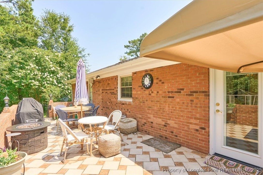 2483 West Carthage Road Lumberton, NC 28360 - Photo 47 of 50 a view of a patio with table and chairs and potted plants