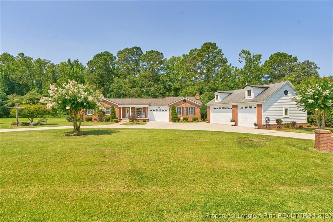 2483 West Carthage Road Lumberton, NC 28360 - Photo 5 of 50 a front view of house with yard and trees in the background