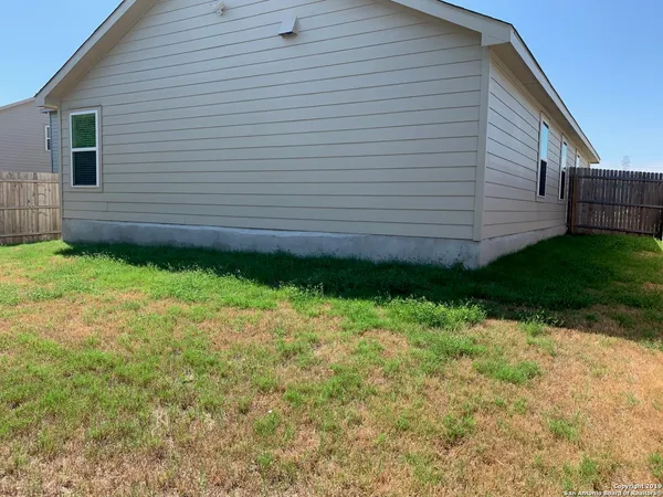 a view of a backyard with pathway