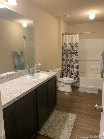 a bathroom with a double vanity sink a mirror and shower