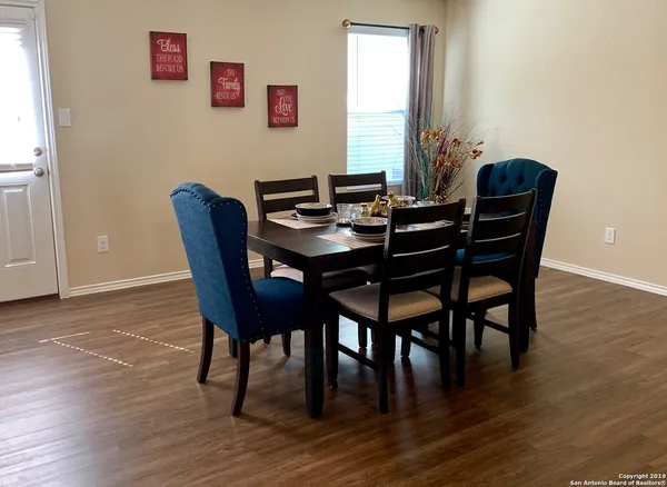 a view of a dining room with furniture and wooden floor
