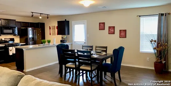 a view of a dining room with furniture and window
