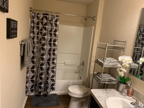 a large bed sitting in a bedroom next to a window