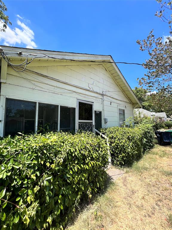 a view of a house with a flower garden