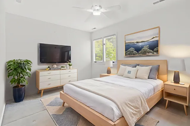 a bedroom with a bed and a flat screen tv