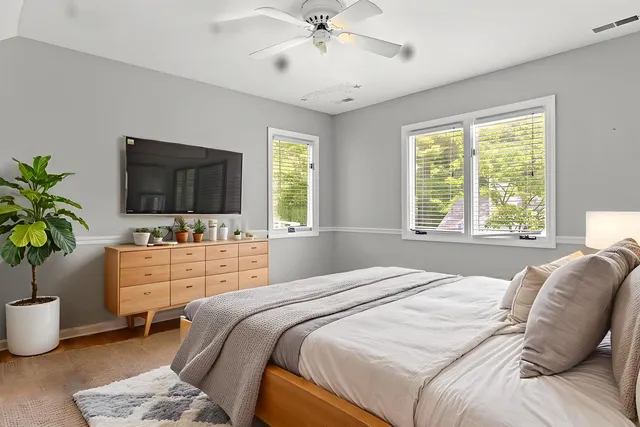 a bedroom with a large bed and a flat screen tv