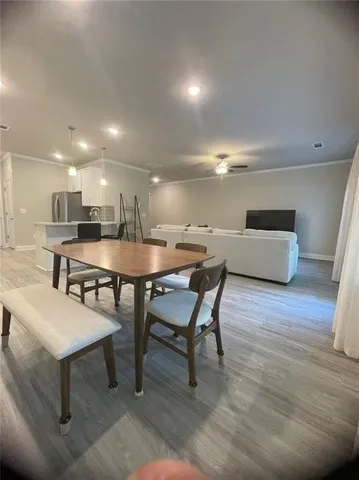 a dining room with furniture and wooden floor