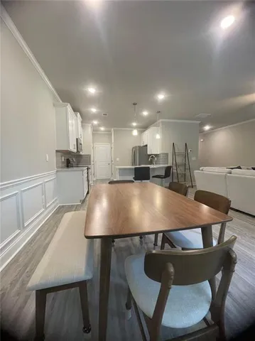 a large kitchen with a table and chairs