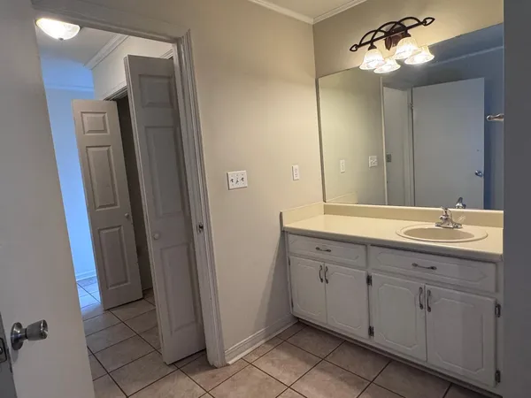 a bathroom with a double vanity sink and a mirror