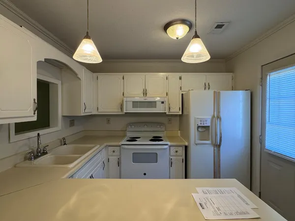 a kitchen with cabinets and stainless steel appliances