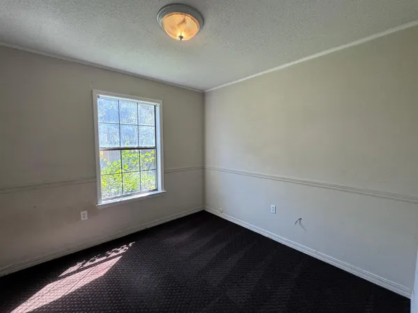 an empty room with a empty space and window