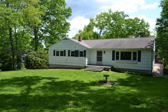 4 Birch Road New Milford, CT 06776 - Photo 1 of 1 a backyard of a house with table and chairs