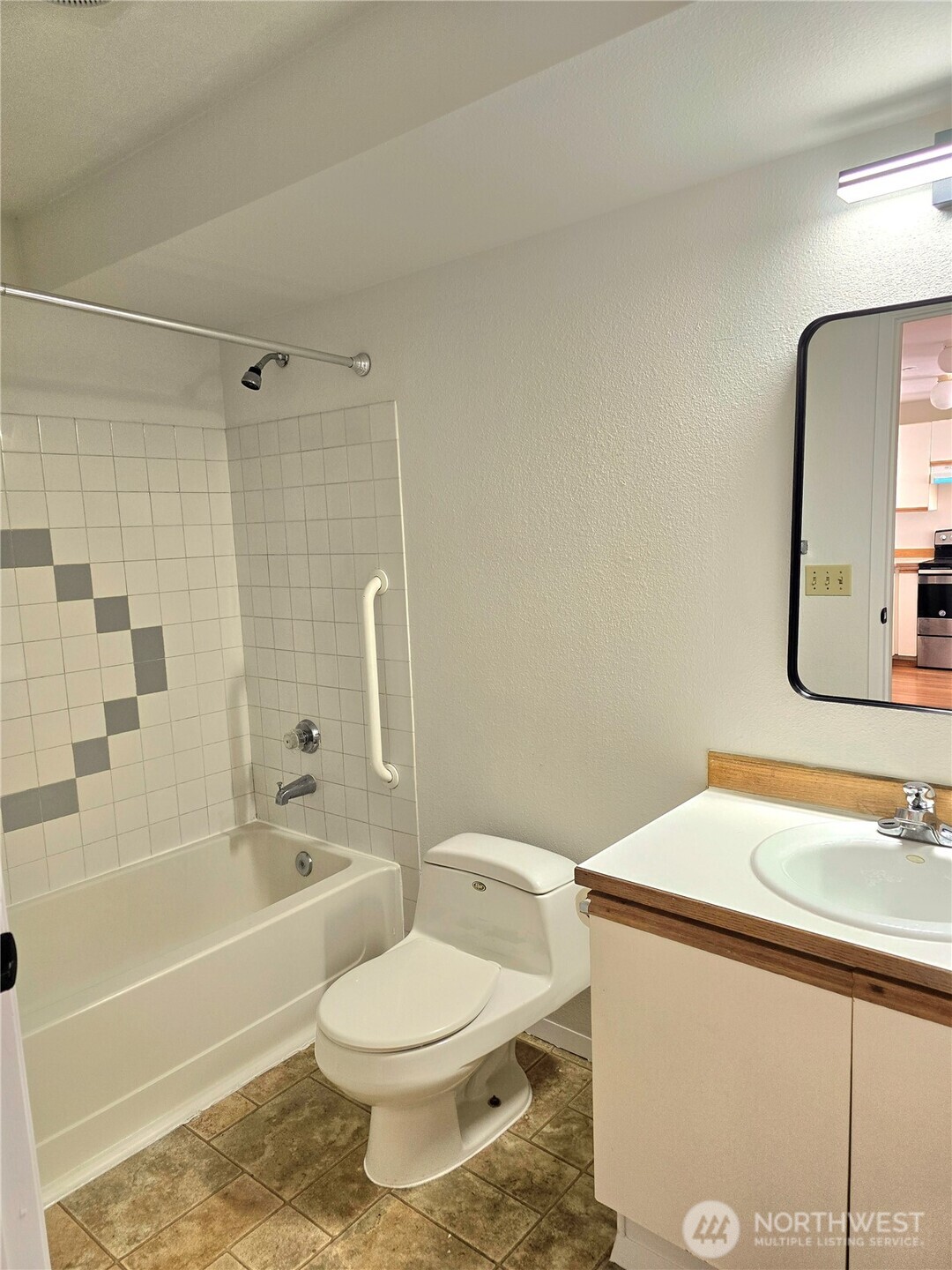 3022 Southwest Bradford Street, Unit 210 Seattle, WA 98126 - Photo 12 of 17 a bathroom with a sink a toilet and shower