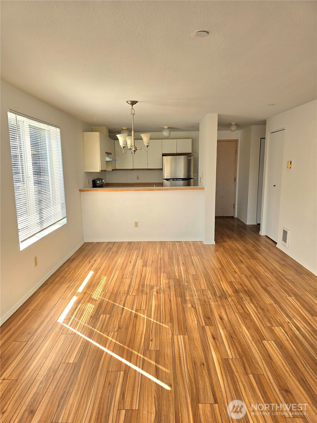 3022 Southwest Bradford Street, Unit 210 Seattle, WA 98126 - Photo 5 of 17 a view of a room with wooden floor and staircase