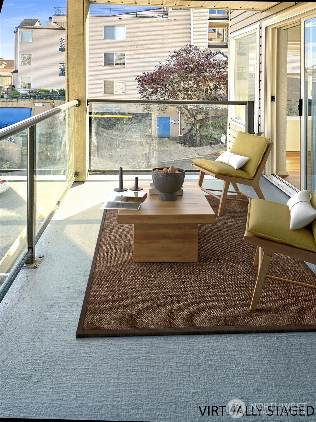 3022 Southwest Bradford Street, Unit 210 Seattle, WA 98126 - Photo 8 of 17 a view of a balcony with floor to ceiling windows with wooden floor