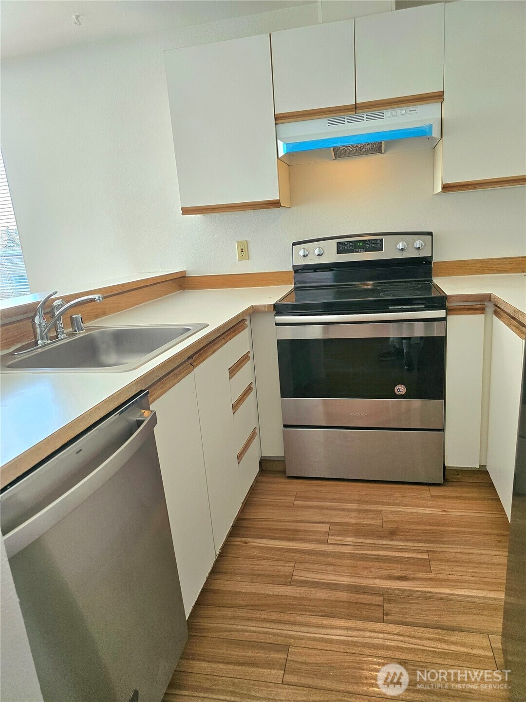 3022 Southwest Bradford Street, Unit 210 Seattle, WA 98126 - Photo 10 of 17 a kitchen with a stove and a sink