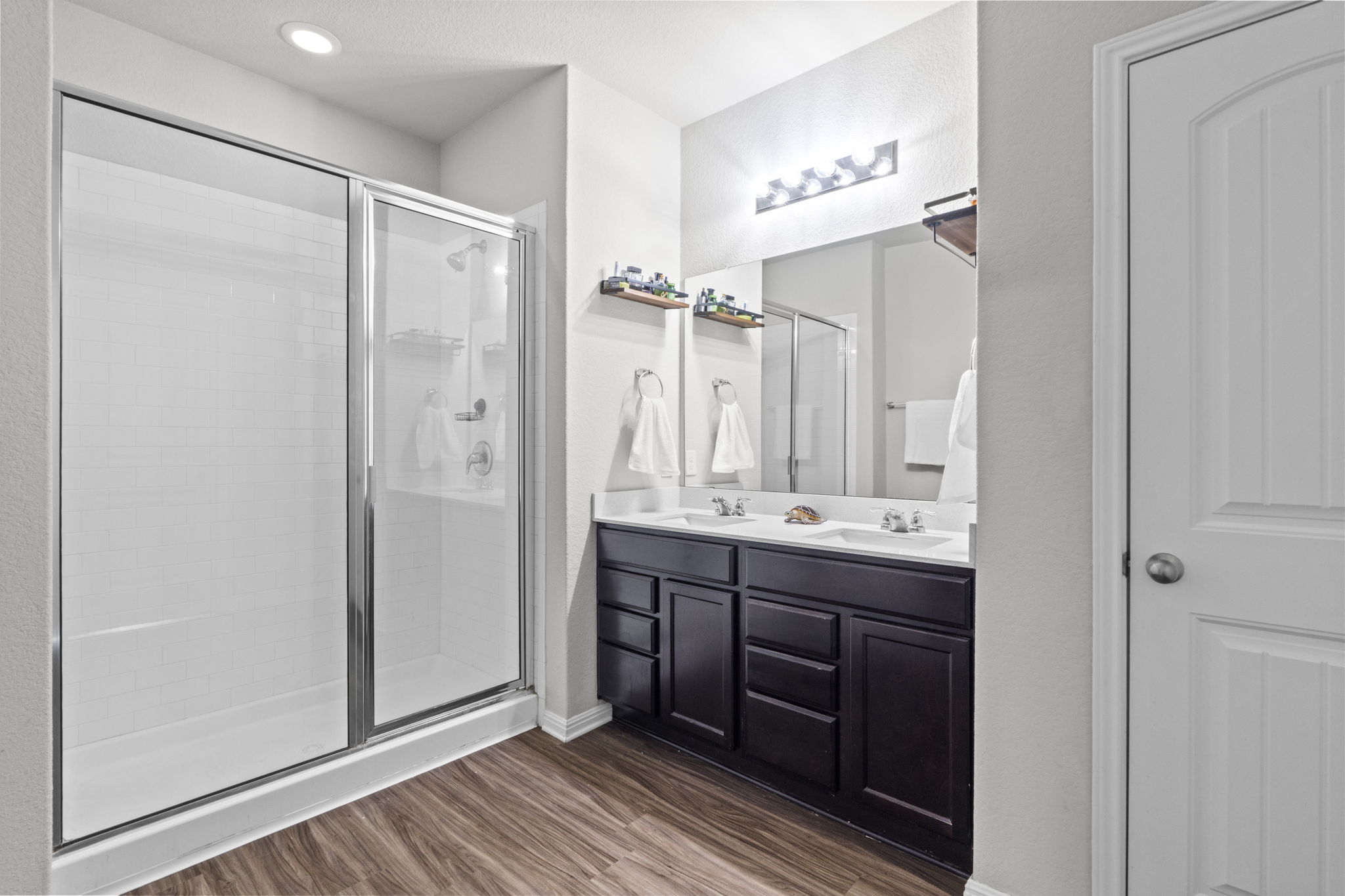 2417 Bridges Ranch Road Georgetown, TX 78628 - Photo 28 of 36 Full bath with double vanity, a stall shower, and dark wood-style floors
