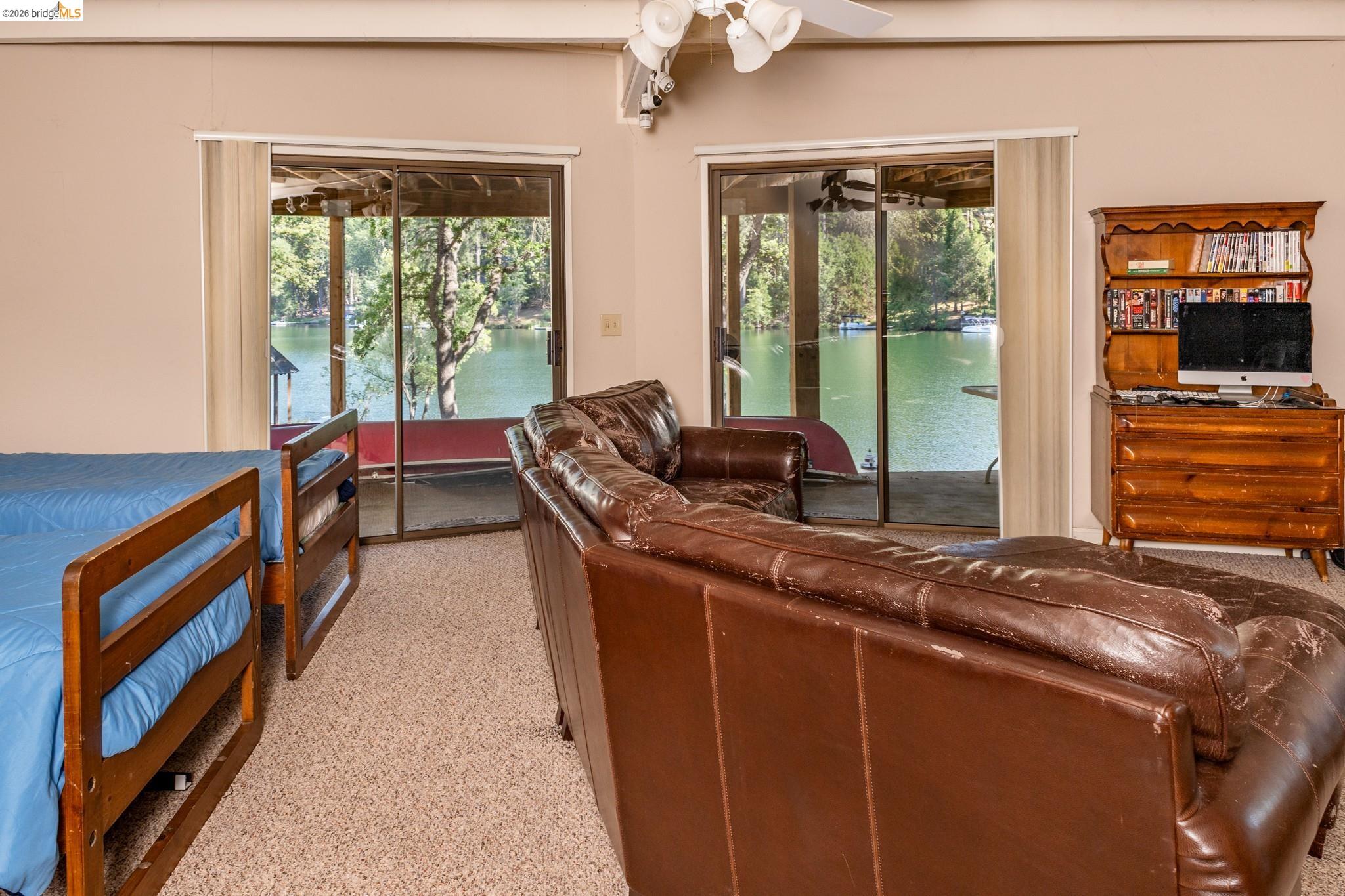 19711 Pleasantview Drive Groveland, CA 95321 - Photo 29 of 39 Interior room featuring direct water frontage and two sets of sliding glass doors
