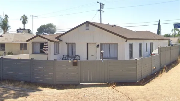 a view of a house with wooden fence