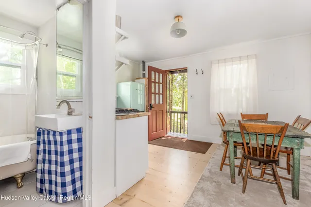 a view of a dining room with furniture and a window