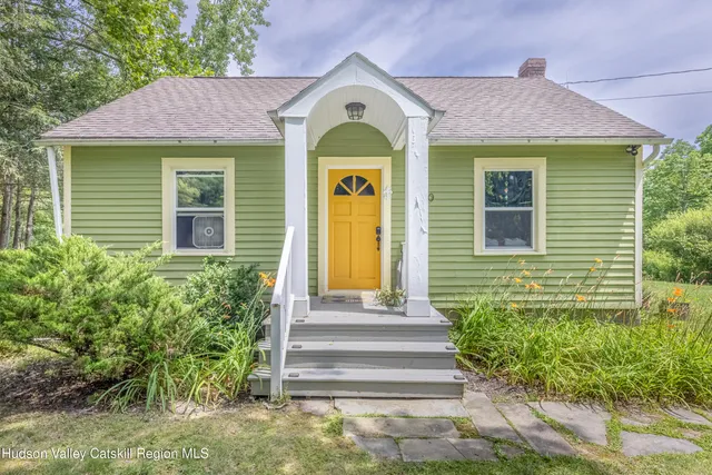 a front view of a house with a garden