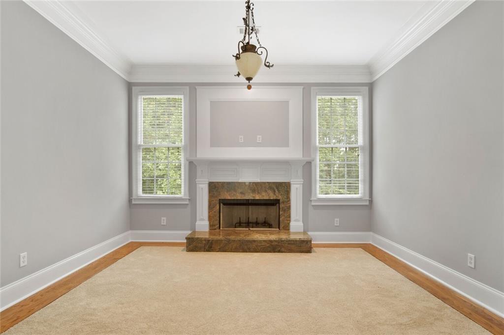 4387 Old Fairburn Road Atlanta, GA 30349 - Photo 14 of 21 an empty room with windows and fireplace